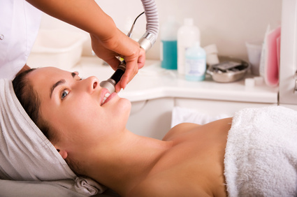 Young woman getting skin cleaning at beauty salon (shallow dof)